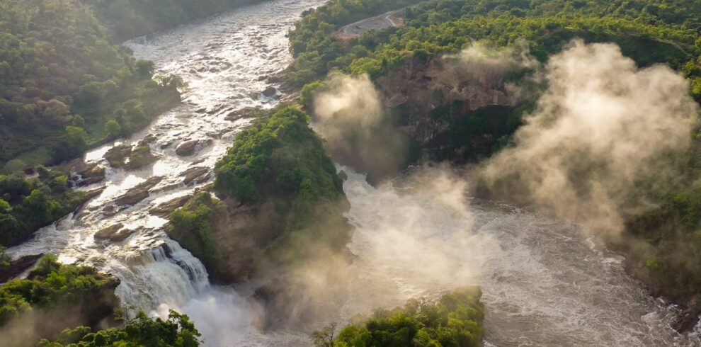 Aerial view of Murchison Falls with mist rising from the Nile gorge