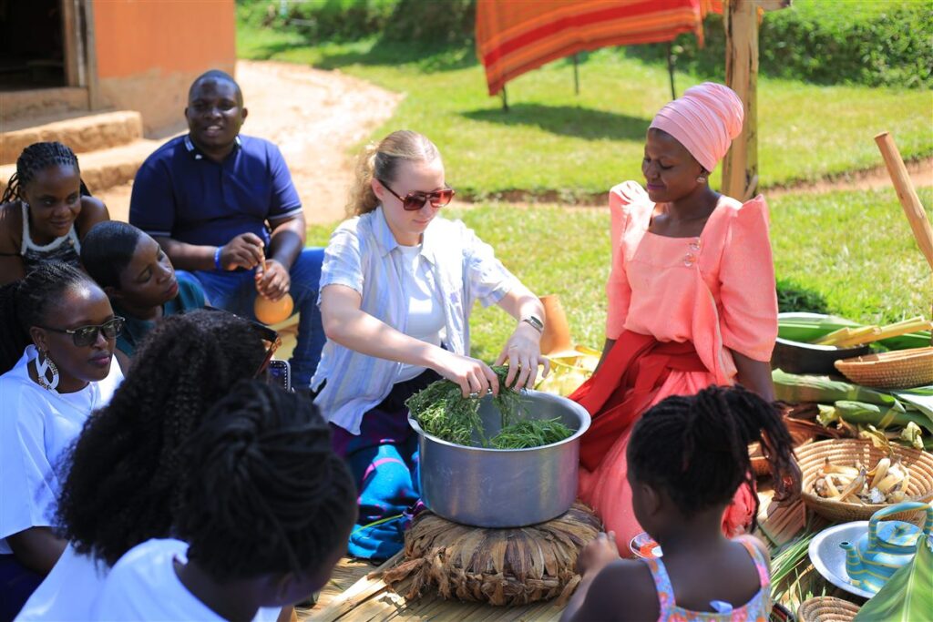 Guests cooking a Buganda meal with village hosts at Ewaffe Cultural Village, Uganda