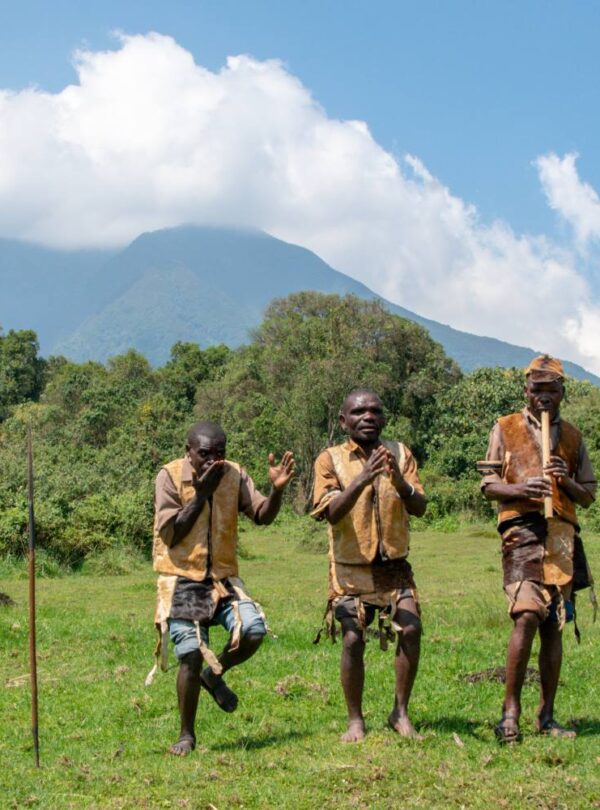 Batwa dancers performing below the Virunga volcanoes in Mgahinga Gorilla National Park
