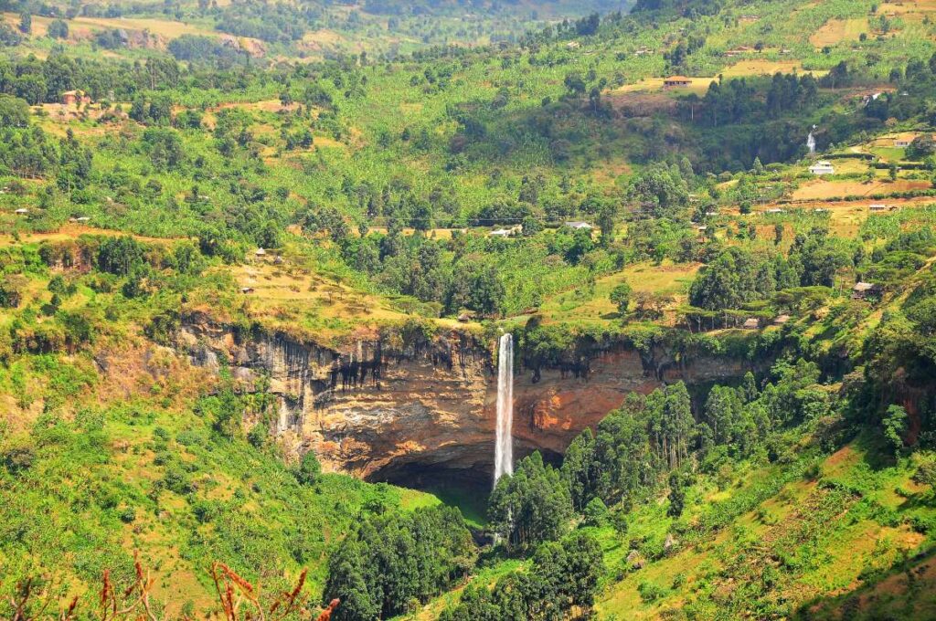 Sipi Falls dropping over a cliff into a green gorge on the slopes of Mount Elgon, Uganda